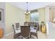 Dining room with glass-top table, wicker chairs, and a window view at 2920 Orangebud Dr, Kissimmee, FL 34746