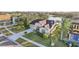 Elevated view of a home with a brown tile roof, a driveway, and lush landscaping at 2920 Orangebud Dr, Kissimmee, FL 34746