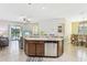 Open concept kitchen and living room area. Kitchen features dark wood cabinetry and stainless steel appliances at 2920 Orangebud Dr, Kissimmee, FL 34746