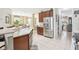 Kitchen with island, stainless steel appliances, and access to pantry/laundry room at 2920 Orangebud Dr, Kissimmee, FL 34746