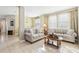 Living room with tiled flooring, two couches, a coffee table, and a dining area at 2920 Orangebud Dr, Kissimmee, FL 34746