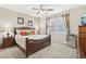 Main bedroom with ceiling fan, carpeted floors, and two windows at 2920 Orangebud Dr, Kissimmee, FL 34746