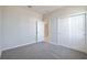 Empty bedroom with gray carpet and white closet doors at 4148 Lavender Ct, Lake Hamilton, FL 33851