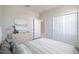 Staged bedroom with a white bed, dresser, and closet doors at 4148 Lavender Ct, Lake Hamilton, FL 33851