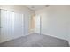 Empty bedroom with gray carpet and white closet doors at 4148 Lavender Ct, Lake Hamilton, FL 33851
