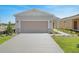 Modern single-story home with a two-car garage and a landscaped front yard at 4148 Lavender Ct, Lake Hamilton, FL 33851