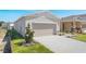 Beautiful home with landscaping, a two-car garage, and a welcoming walkway at 4148 Lavender Ct, Lake Hamilton, FL 33851