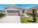 Inviting home exterior with a paved driveway, attached garage, and landscaped walkway at 4148 Lavender Ct, Lake Hamilton, FL 33851