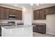 Kitchen with granite countertops, stainless steel appliances, and dark wood cabinets at 4148 Lavender Ct, Lake Hamilton, FL 33851