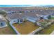 Fenced backyard with screened porch, solar panels, and a view of surrounding homes at 473 Disa Dr, Davenport, FL 33837