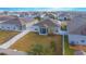 Aerial view of a home with a fenced backyard, solar panels, and a screened porch at 473 Disa Dr, Davenport, FL 33837