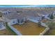 Fenced backyard with a screened porch, solar panels, and a view of a nearby sports field at 473 Disa Dr, Davenport, FL 33837