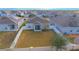 Aerial view of a home with fenced backyard, screened porch, and solar panels at 473 Disa Dr, Davenport, FL 33837