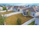 Aerial view of a home with a fenced backyard, solar panels, and a screened porch at 473 Disa Dr, Davenport, FL 33837