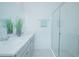 Modern bathroom with double vanity, glass shower, and gray cabinets at 473 Disa Dr, Davenport, FL 33837