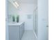Clean, modern bathroom featuring a double vanity, glass shower, and gray cabinetry at 473 Disa Dr, Davenport, FL 33837