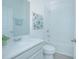 Simple bathroom with white vanity, shower/tub combo, and wood-look tile at 473 Disa Dr, Davenport, FL 33837