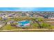 Community pool with lounge chairs, shade structures, and a playground at 473 Disa Dr, Davenport, FL 33837