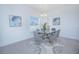 Elegant dining area with a glass-top table, plush chairs, and decorative artwork at 473 Disa Dr, Davenport, FL 33837