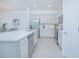 Modern kitchen featuring white cabinetry, stainless steel appliances, and an island at 473 Disa Dr, Davenport, FL 33837