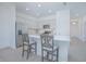 Stylish kitchen with island seating, stainless steel appliances, and white cabinetry at 473 Disa Dr, Davenport, FL 33837