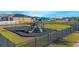 Community playground with slides, climbing wall, and swings at 473 Disa Dr, Davenport, FL 33837