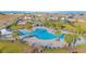 Community pool with a cabana, lounge chairs, and lush landscaping at 473 Disa Dr, Davenport, FL 33837