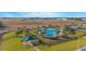 Community pool with a cabana, surrounded by lush green grass at 473 Disa Dr, Davenport, FL 33837