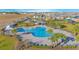 An aerial view of the community pool, cabana, and lounge chairs at 473 Disa Dr, Davenport, FL 33837