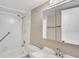 Bathroom with a shower/tub combo, white vanity, and tiled walls at 6030 Village Cir, Orlando, FL 32822