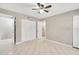 Bedroom with tiled flooring, a ceiling fan, and white closet doors at 6030 Village Cir, Orlando, FL 32822