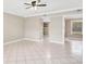 Spacious living room with tile flooring, a ceiling fan, and neutral-colored walls at 6030 Village Cir, Orlando, FL 32822