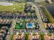 Aerial view of community pool, playground, and surrounding homes at 781 Ocean Course Ave # 601, Davenport, FL 33896