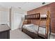bedroom with bunk bed and brick feature wall at 781 Ocean Course Ave # 601, Davenport, FL 33896