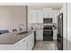 Modern kitchen with stainless steel appliances and white cabinets at 781 Ocean Course Ave # 601, Davenport, FL 33896
