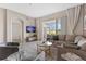 Living room with sectional sofa, sliding doors to patio, and TV at 781 Ocean Course Ave # 601, Davenport, FL 33896