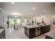 Open kitchen and dining area with island, dark wood cabinets, and sliding glass doors at 1660 Andover Ridge Dr, Deland, FL 32720