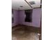 Small bedroom with purple walls and concrete floor at 1918 Mountain Lake Cutoff Rd, Lake Wales, FL 33859