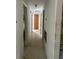 Long hallway with multiple doors to bedrooms at 1918 Mountain Lake Cutoff Rd, Lake Wales, FL 33859