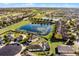 Aerial perspective of homes in a residential area surrounding a small pond at 2213 Grantham Ave, Davenport, FL 33837