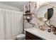 Stylish bathroom with marble accent wall, round mirror, and modern fixtures at 2213 Grantham Ave, Davenport, FL 33837