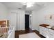 Well-lit Bedroom with closet, changing table, and crib at 2213 Grantham Ave, Davenport, FL 33837