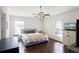 Bedroom with wood-look flooring, a comfortable bed, and windows with blinds at 2213 Grantham Ave, Davenport, FL 33837