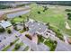 Aerial view of a golf course clubhouse with a pool, parking lot, and surrounding community at 2213 Grantham Ave, Davenport, FL 33837