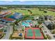 Aerial view of community amenities including the pool, tennis courts, a playground, and golf course at 2213 Grantham Ave, Davenport, FL 33837