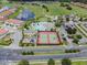 Aerial view of tennis courts, pool, playground, and golf course in the background at 2213 Grantham Ave, Davenport, FL 33837