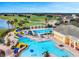 Community pool with slides and areas for lounging at 2213 Grantham Ave, Davenport, FL 33837
