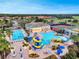 Aerial view of community pool with waterslide, lap pool, and lounge chairs at 2213 Grantham Ave, Davenport, FL 33837