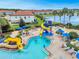 Community pool with waterslide, surrounded by lounge chairs and umbrellas at 2213 Grantham Ave, Davenport, FL 33837