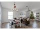 Dining area with a farmhouse-style table and a view of the decorated living room at 2213 Grantham Ave, Davenport, FL 33837